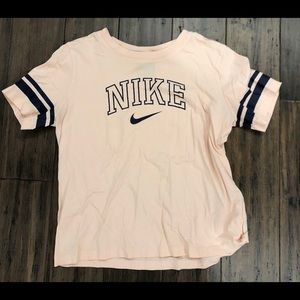 A light pink Nike crop top